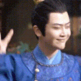 a man in a blue robe is waving his hand .