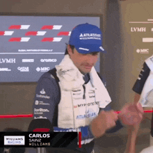 a man wearing a hat that says atlassian williams racing on it