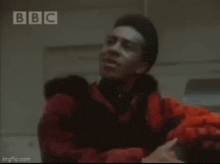 a blurry picture of a group of people standing in front of a bbc sign