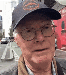 a man wearing glasses and a hat that says colorado on it