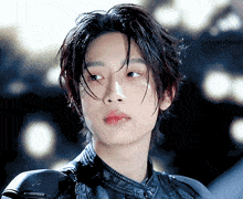 a close up of a young man with wet hair