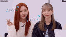 two girls are sitting next to each other and one has the letter j on her shirt