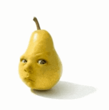 a pear with a baby 's face on it on a white background