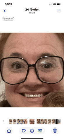 a phone screen shows a picture of a woman wearing glasses and the date 24 february
