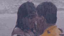 a woman is touching a man 's face with her hand