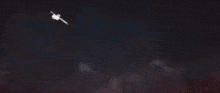 a blurry image of a person holding a sword with a blue light coming out of it