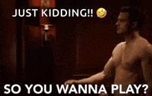 a shirtless man is pointing at another shirtless man with the words `` just kidding ! ''