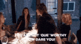 a group of women are sitting around a table and one of them says " you are not "