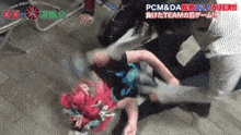 a group of people are wrestling a person on the ground .