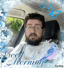 a man with glasses and a beard is sitting in a car with a good morning message