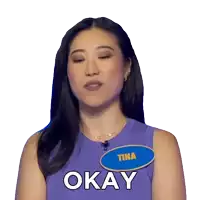 a woman in a purple tank top with a name tag that says tina