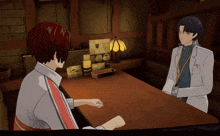 a man and a woman are sitting at a table and the man has a name tag that says ' a ' on it