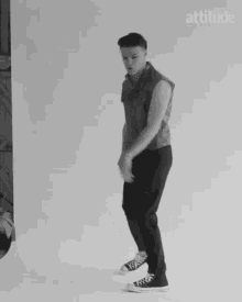 a black and white photo of a man dancing with the word attitude behind him