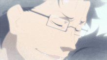 a close up of a man 's face with glasses