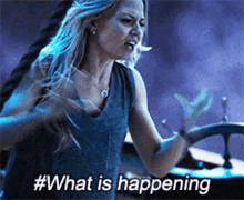 a woman is holding a steering wheel and says #what is happening ..