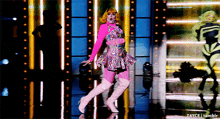 a woman in a pink dress and pink boots is dancing on a stage with a watermark that says t4yce tumblr