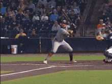 a baseball player is swinging at a pitch with a true sign in the background