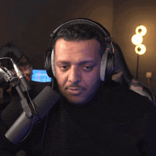a man wearing headphones looks at the camera