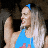 a woman wearing a blue tank top with a spongebob design on it