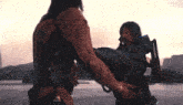 a man and a woman are standing next to each other and the woman is carrying a backpack