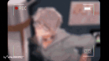 a blurry picture of a person is being recorded with the words rec on the bottom