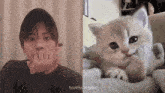 a man is biting his nails next to a kitten