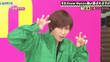 a man in a green jacket is making a funny face in front of a pink background that says snow man