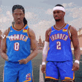 two basketball players wearing blue thunder uniforms