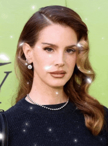 a close up of a woman wearing a black sweater and pearls