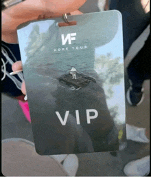 a person is holding up a vip pass for the hope tour