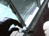 a person 's hand is reaching into a window
