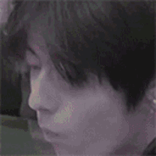 a close up of a person 's face with their eyes closed and their mouth open .
