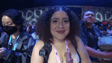 a woman wearing a lanyard that says g-shock is smiling