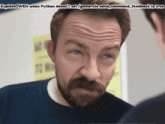 a man with a beard looks at himself in a mirror with a caption that says explainowen
