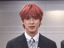 a man with red hair and a suit and tie
