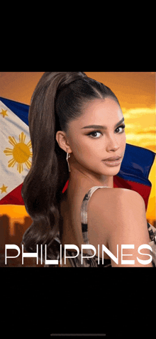 a woman is standing in front of a flag and the word philippines