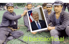 a group of men holding a picture of donald trump