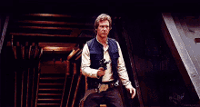 han solo from star wars is holding a gun in his hand while standing in a hallway .