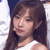 a close up of a girl 's face with a microphone