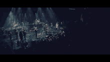 a group of people singing on a stage with a crowd watching