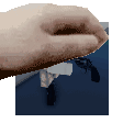 a close up of a person 's hand with a gun in the background