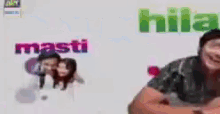 a man is smiling in front of a screen that says hila