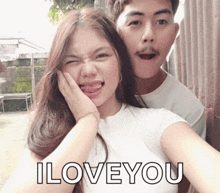 a man and a woman are posing for a picture with the words " i love you " above them