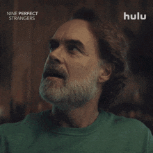 a man with a beard is wearing a green shirt that says hulu on it