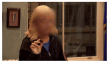 a blurred image of a woman eating a cookie