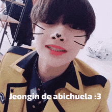 a young boy in a school uniform with the words jeongin de abichuela : 3 written on his face