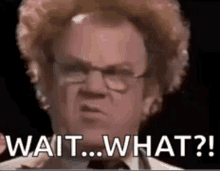 a man with curly hair and glasses is making a funny face and saying `` wait what ? ''