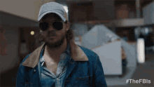 a man wearing sunglasses and a hat with the hashtag #thefbls on the bottom right