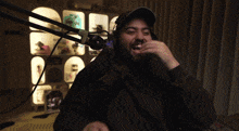 a man wearing headphones is sitting in a chair laughing