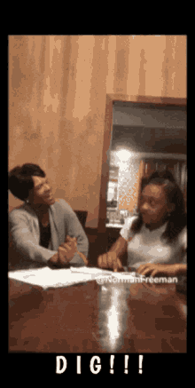 a woman and a girl are sitting at a table with the word dig written on the bottom